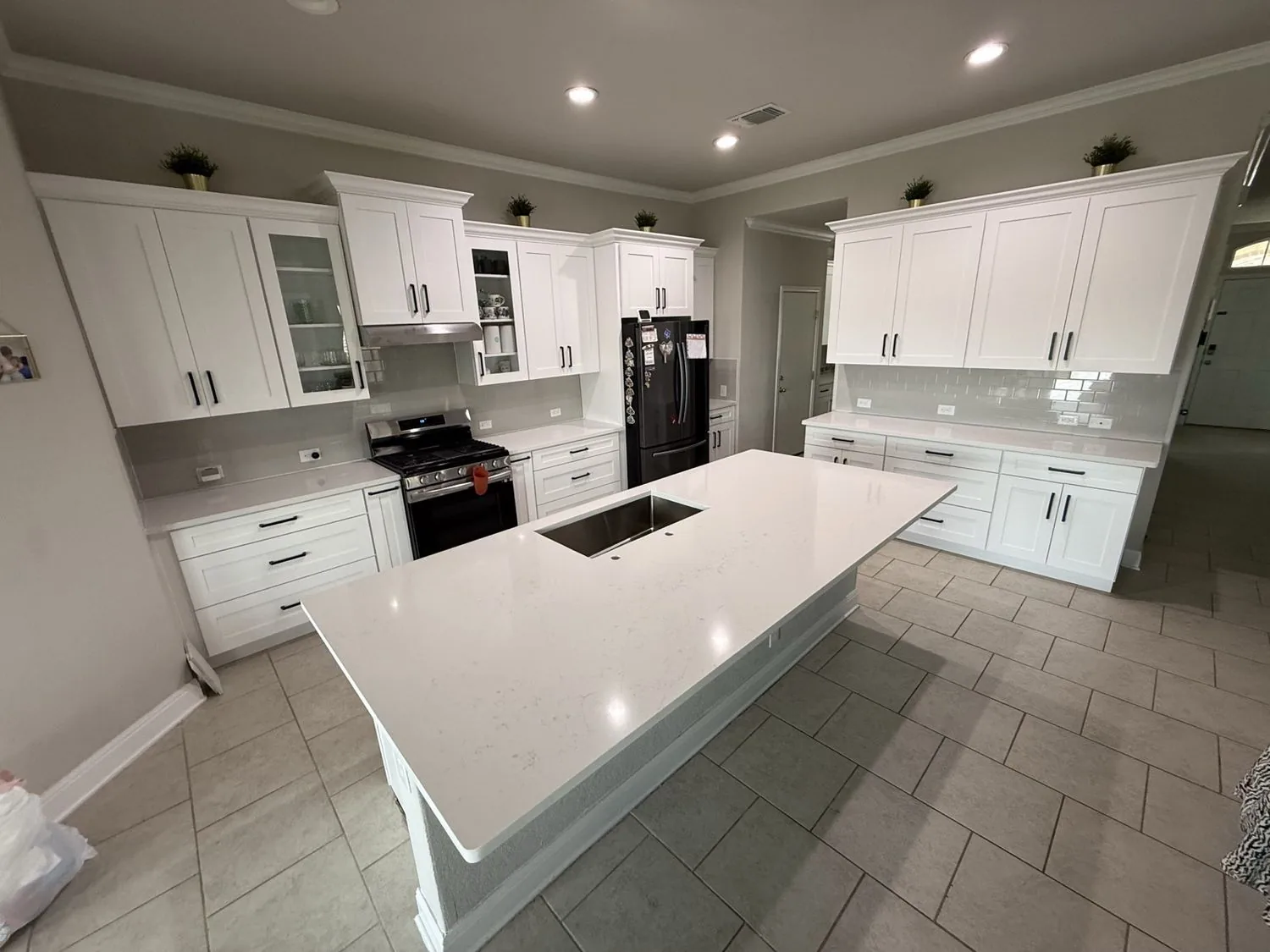 Bright white shaker kitchen with a large quartz island in San Antonio