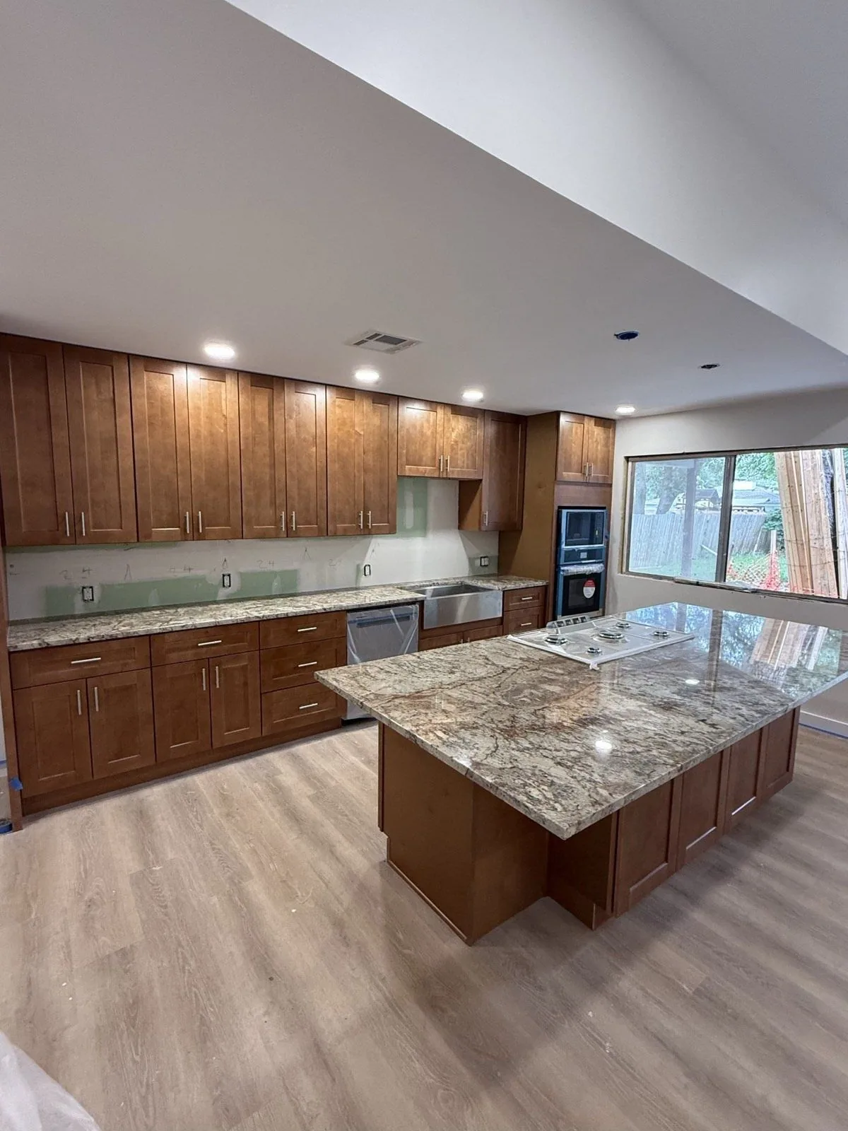 Open plan maple kitchen with a large granite island in San Antonio